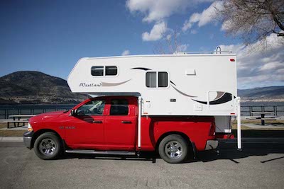 The Westland RV Travelaire 80WS Truck Camper parked next to a lake in BC