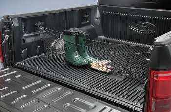 A Ford bed net stretched across a F-350 Super Duty and holding boots and gloves in place.
