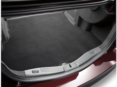 Close-up of a black floor mat in the open trunk of a Ford Fusion.