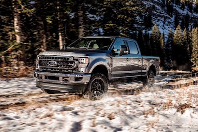 <a href="https://clients.webstager.com/skahaford.com/2021-ford-f250-in-bc"><img src="images/upload/March_2022/CN-13-2022-Ford-f250-exterior-penticton-bc.jpg"alt="A 2021 Ford F-250 with a Lariat Black Package driving through a snow-covered field"/></a>